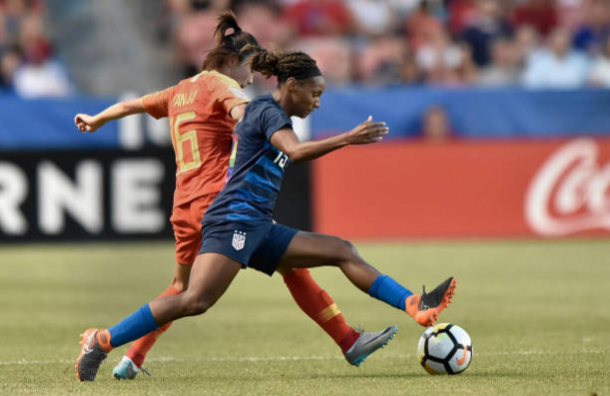 USWNT forward Crystal Dunn challenges China's Yan Jinjin for the ball. | Photo: Gene Sweeney Jr - Getty Images