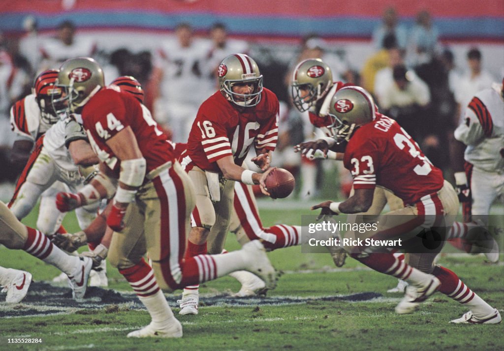 Joe Montana #16, Quarterback for the San Francisco 49ers hands the ball off to running back #33 Roger Craig during the National Football League Super Bowl XXIII game against the Cincinnati Bengals on 22 January 1989 at the Joe Robbie Stadium, Miami, Florida, United States. The 49ers won the game 20 - 16. (Photo by Rick Stewart/Allsport/Getty Images)