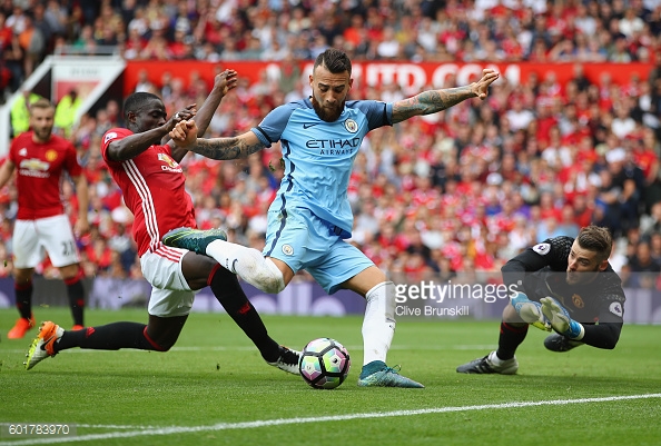 Eric Bailly tackles Nicolas Otamendi as he shoots at goal during the Manchester derby. | Photo: Clive Brunskill/Getty Images