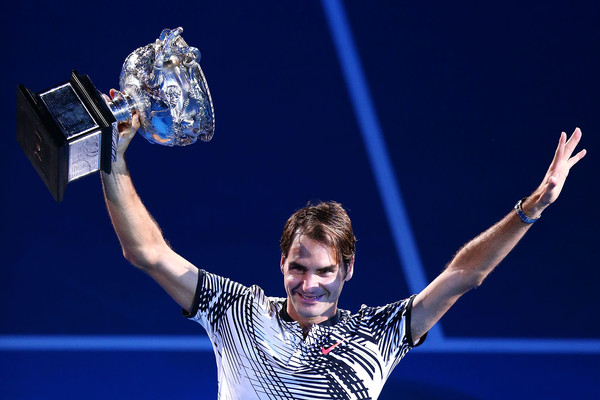 Federer holds the Norman Brookes Challenge Cup for the fifth time in his career (Photo by Jack Thomas / Getty)