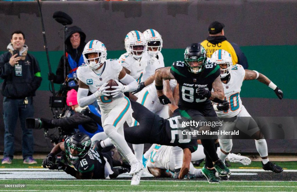 Miami Dolphins safety Jevon Holland (8) runs after intercepting a pass during second quarter of an NFL football game against the New York Jets at MetLife Stadium on Friday, Nov. 24, 2023, in East Rutherford, New Jersey. (David Santiago/Miami Herald/Tribune News Service via Getty Images)