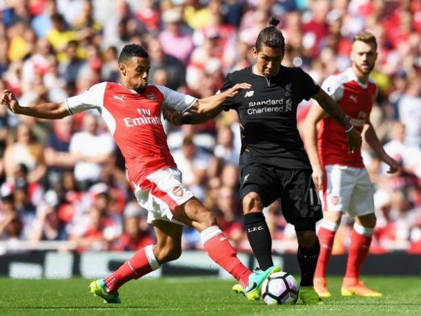 Roberto Firmino and Francis Coquelin contest for possession | Photo: Getty images