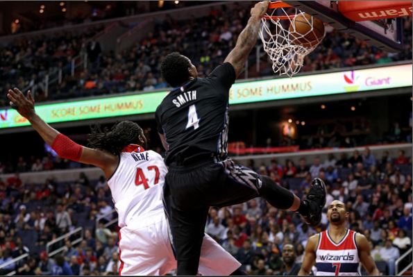 Smith dunks during a game. ​Patrick Smith/Getty Images North America