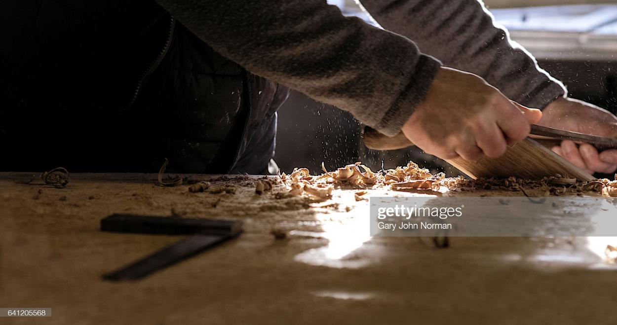 A working-class man is fitting together some furniture: Gary John Norman/GettyImages 