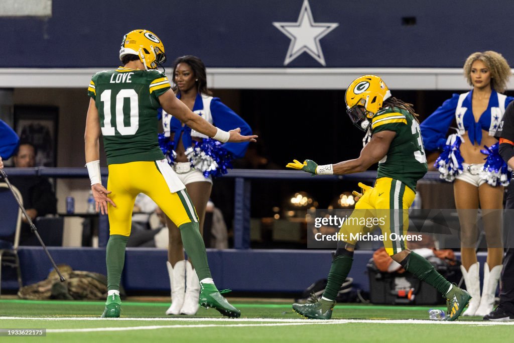 Aaron Jones #33 of the Green Bay Packers celebrates with Jordan Love #10 of the Green Bay Packers after scoring a touchdown during an NFL wild-card playoff football game between the Dallas Cowboys and the Green Bay Packers at AT&T Stadium on January 14, 2024 in Arlington, Texas. (Photo by Michael Owens/Getty Images)