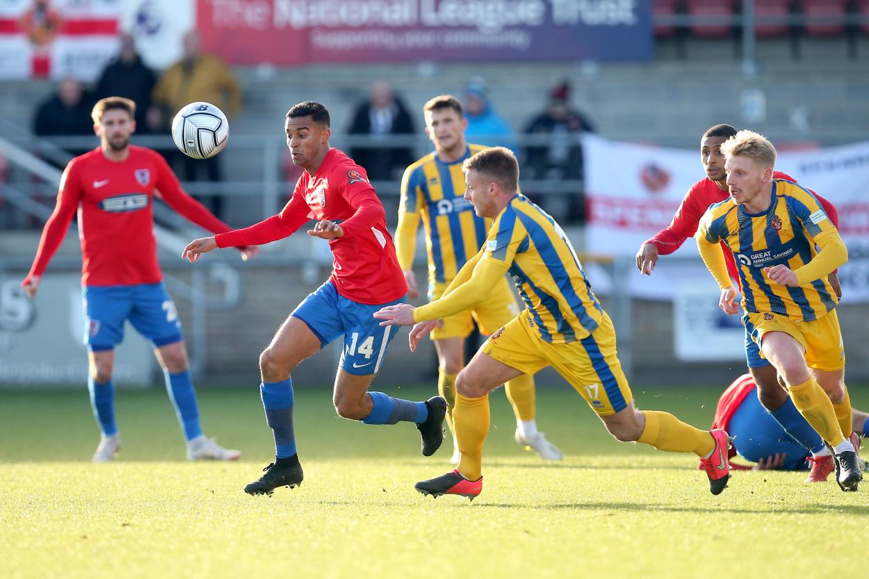 George Saunders of Dagenham & Redbridge and Ryan Hall of Spennymoor battle for the ball - Credit: Gavin Ellis/TGS Photo