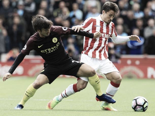 David Silva and Bojan battle for the ball. Photo: Getty.