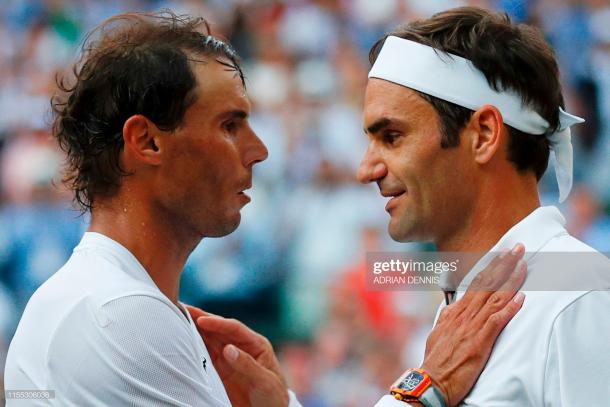 Nadal (l.) and Federer (r.) share a warm exchange at the net after their semifinal/Getty Images