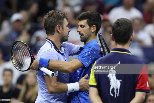 Wawrinka consoles Djokovic after the Serb was forced to retire/Photo: Matthew Stockman/Getty Images