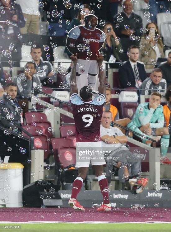 LONDON, ENGLAND - AUGUST 23: West Ham United's Michail Antonio celebrates scoring his side's third goal by lifting a cardboard cut out of himself during the Premier League match between West Ham United and <strong><a  data-cke-saved-href='https://www.vavel.com/en/football/2021/10/29/leicester-city/1090986-leicester-city-vs-arsenal-predicted-line-ups.html' href='https://www.vavel.com/en/football/2021/10/29/leicester-city/1090986-leicester-city-vs-arsenal-predicted-line-ups.html'>Leicester City</a></strong> at The London Stadium on August 23, 2021 in London, England. (Photo by Rob Newell - CameraSport via Getty Images)