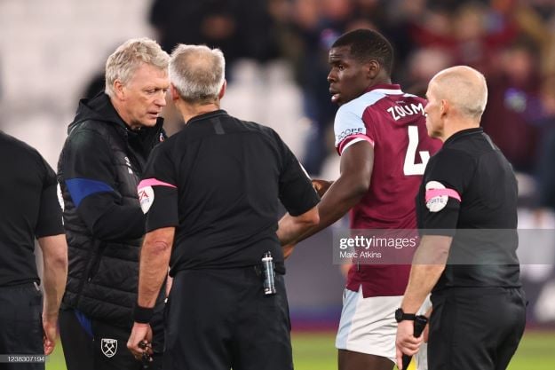 LONDON, ENGLAND - FEBRUARY 08: Kurt Zouma of West Ham United looks on as manager David Moyes speaks to the match officials during the Premier League match between West Ham United and Watford at London Stadium on February 8, 2022 in London, United Kingdom. (Photo by Marc Atkins/Getty Images)