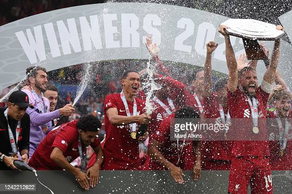 Photo by Mark Atkins/GettyImages. Jordan Henderson lifts the Community Shield.