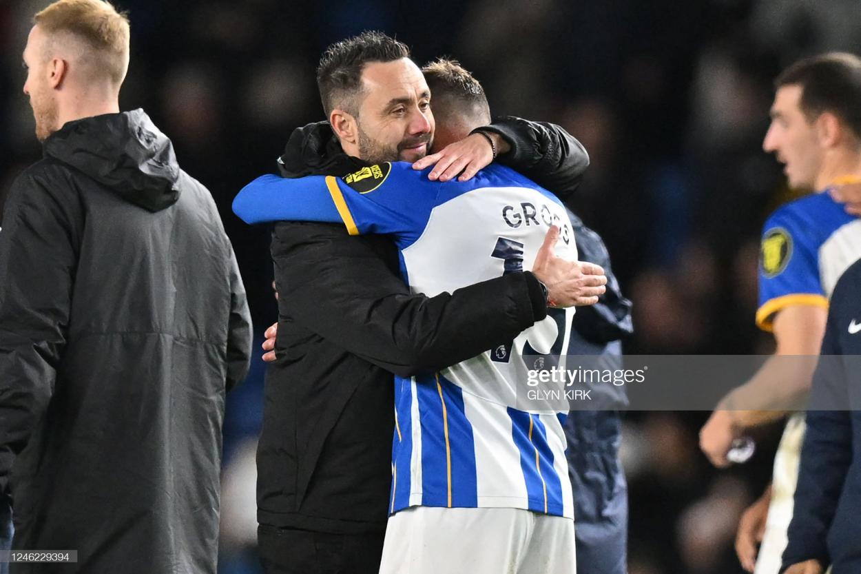 Brighton's Italian head coach Roberto De Zerbi (L) embraces Brighton's German midfielder Pascal Gross (R) on the pitch after the English Premier League football match between Brighton and Hove Albion and Liverpool at the American Express Community Stadium in Brighton, southern England on January 14, 2023. (Photo by GLYN KIRK/AFP via Getty Images)