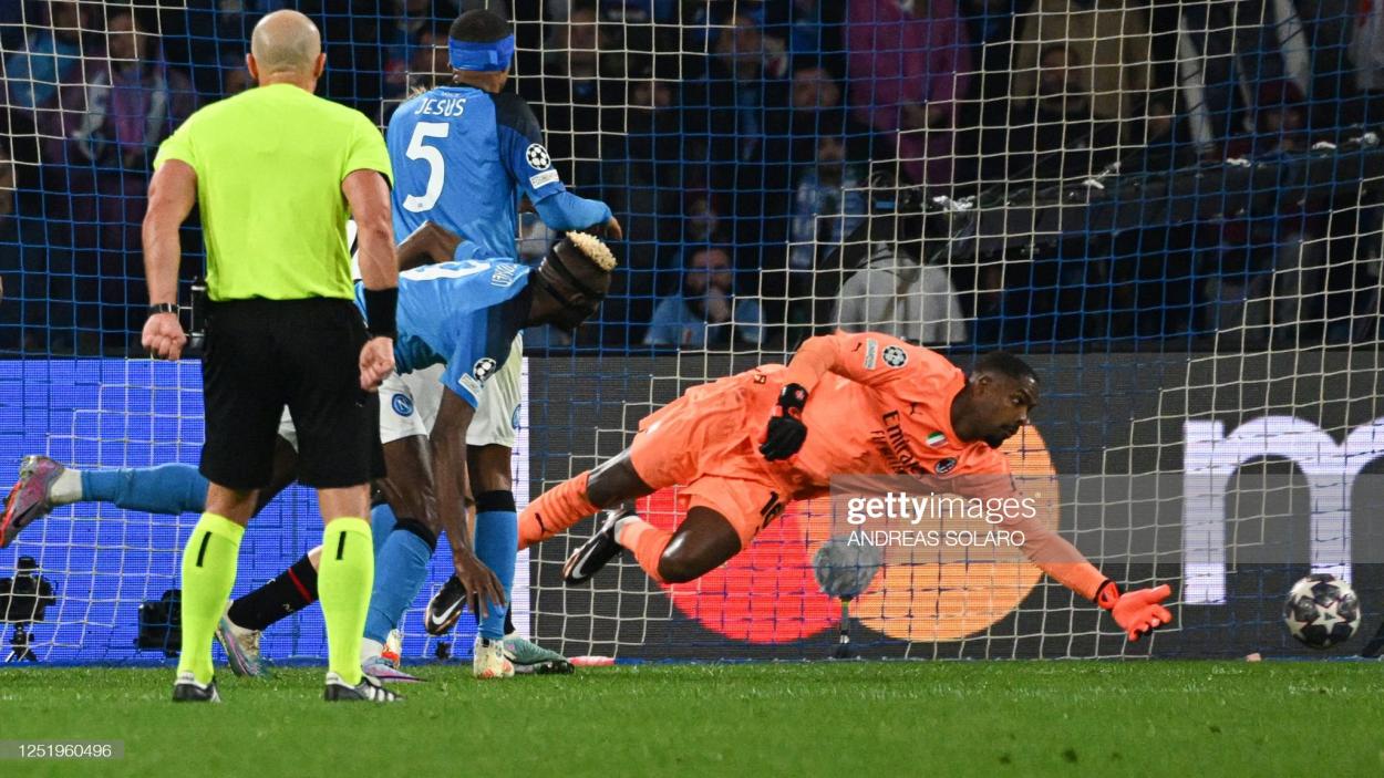 Victor Osimhen of Napoli scores past Mike Maignan of AC Milan (Photo by ANDREAS SOLARO/AFP via Getty Images)