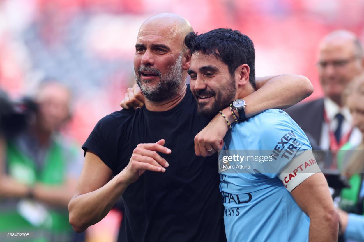 Pep Guardiola celebrates winning the FA Cup with <strong><a  data-cke-saved-href='https://www.vavel.com/en/football/2022/05/22/manchester-city/1112491-manchester-city-3-2-aston-villa-citizens-retain-premier-league-title-after-stunning-second-half-comeback.html' href='https://www.vavel.com/en/football/2022/05/22/manchester-city/1112491-manchester-city-3-2-aston-villa-citizens-retain-premier-league-title-after-stunning-second-half-comeback.html'>Ilkay Gundogan</a></strong> (Photo by Marc Atkins/Getty Images)