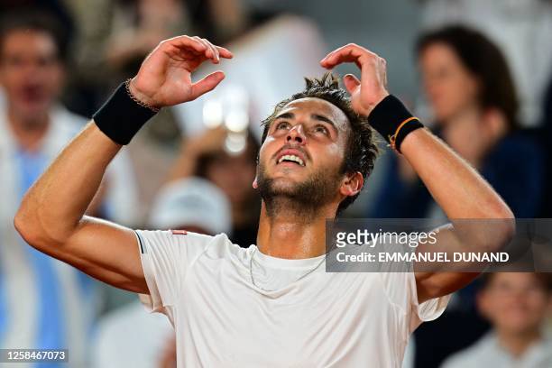 Etcheverry looks up to the sky after advancing to the French Open quarterfinals/Photo: Emmanuel Dunand/AFP via Getty Images