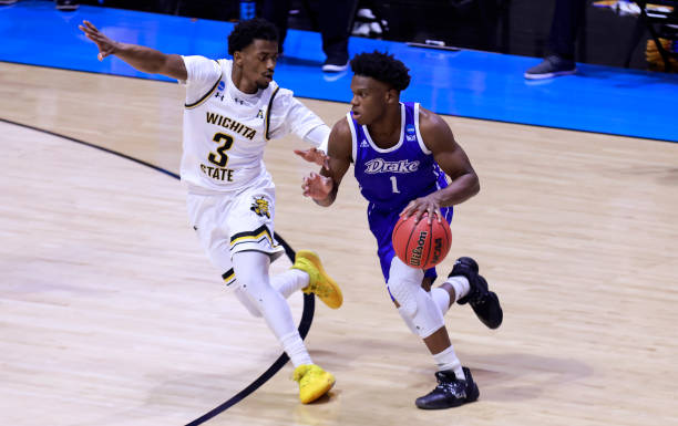 Joseph Yesufu (r.) drives on Alterique Gilbert (r.) at Mackey Arena/Photo: Justin Casterline/Getty Images