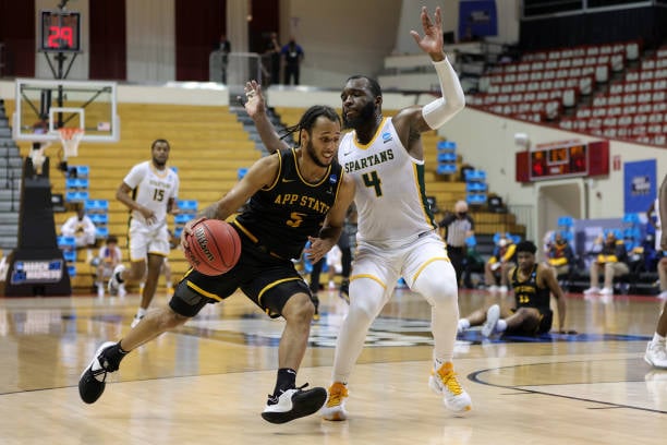 Michael Almonacy of Appalachian State (l.) drives past Joe Bryant Jr. of Norfolk State (r.) during their First Four game/Photo: Stacy Revere/Getty Images