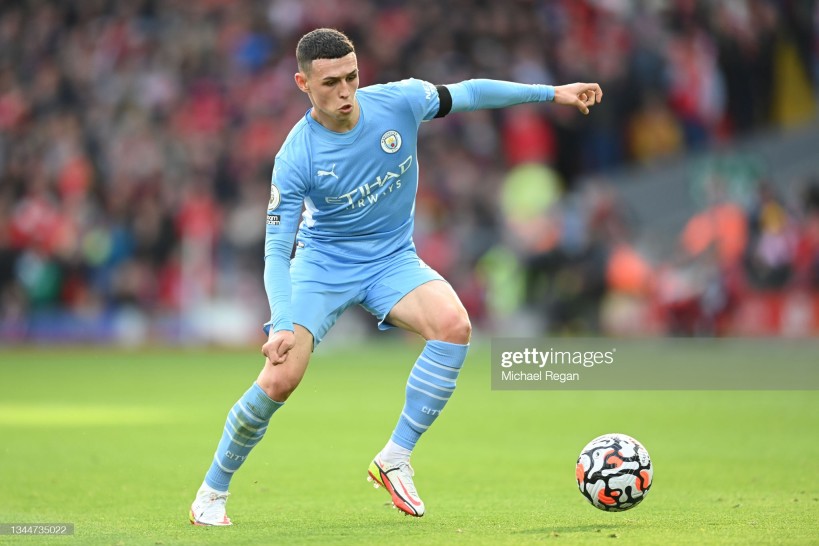 LIVERPOOL, ENGLAND - OCTOBER 03: <strong><a  data-cke-saved-href='https://www.vavel.com/en/football/2021/06/05/manchester-city/1073735-manchester-city-202021-season-review-the-premier-league-title-returns-to-the-etihad-in-yet-another-record-breaking-season.html' href='https://www.vavel.com/en/football/2021/06/05/manchester-city/1073735-manchester-city-202021-season-review-the-premier-league-title-returns-to-the-etihad-in-yet-another-record-breaking-season.html'>Phil Foden</a></strong> of Manchester City in action during the <strong><a  data-cke-saved-href='https://www.vavel.com/en/football/2021/09/18/manchester-city/1086355-the-warmdown-saints-defend-religiously-in-0-0-stalemate.html' href='https://www.vavel.com/en/football/2021/09/18/manchester-city/1086355-the-warmdown-saints-defend-religiously-in-0-0-stalemate.html'>Premier League</a></strong> match between Liverpool and Manchester City at Anfield on October 03, 2021 in Liverpool, England. (Photo by Michael Regan/Getty Images)