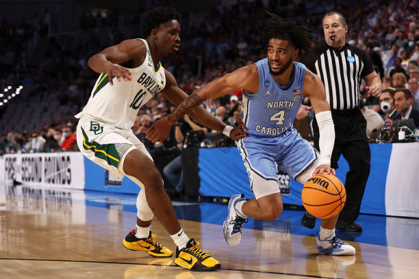 R.J. Davis of <strong><a  data-cke-saved-href='https://vavel.com/en-us/ncaa/2014/10/08/college-basketball/400997.html' href='https://vavel.com/en-us/ncaa/2014/10/08/college-basketball/400997.html'>North Carolina</a></strong> tries to drive past Adam Flagler of Baylor during the Tar Heels' second round victory/Photo: Tom Pennington/Getty Images