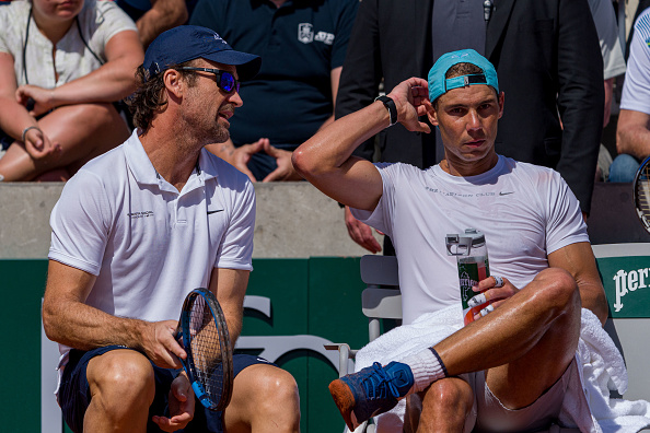 Nadal talking with coach Carlos Moya (Andy Cheung/Getty Images)