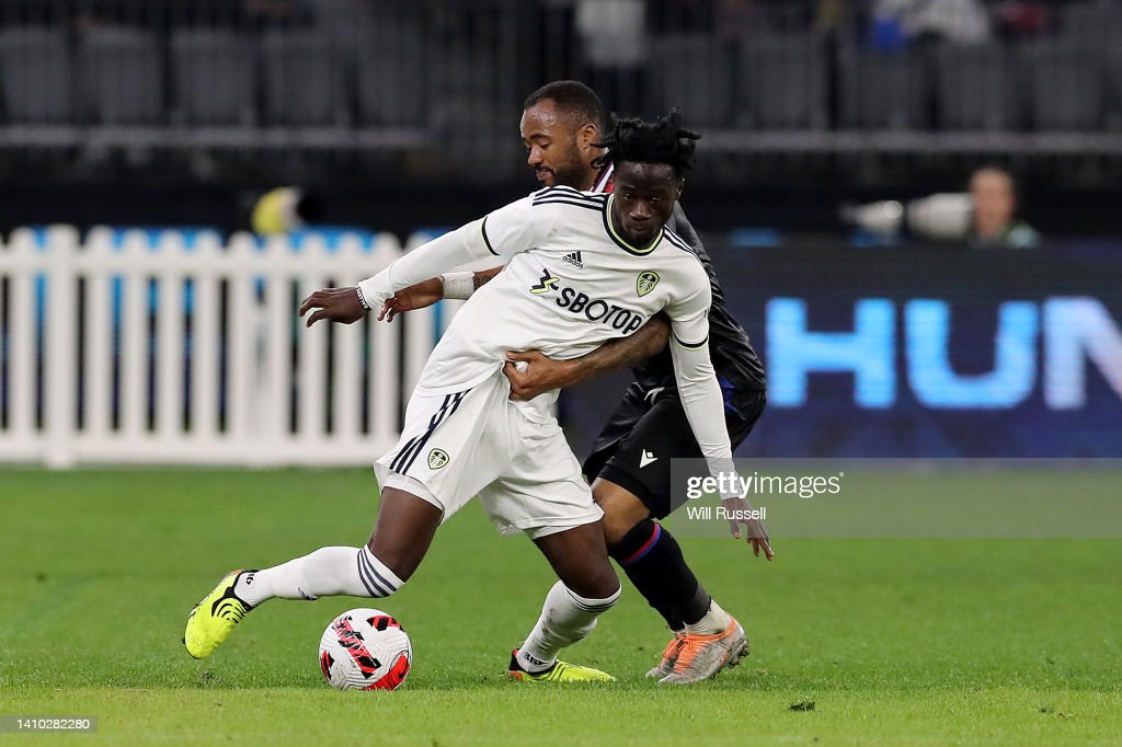 PERTH, AUSTRALIA - JULY 22: Darko Gyabi of Leeds United controls the ball under pressure from Jordan Ayew of Crystal Palace during the Pre-Season friendly match between Leeds United and Crystal Palace at Optus Stadium on July 22, 2022 in Perth, Australia. (Photo by Will Russell/Getty Images)