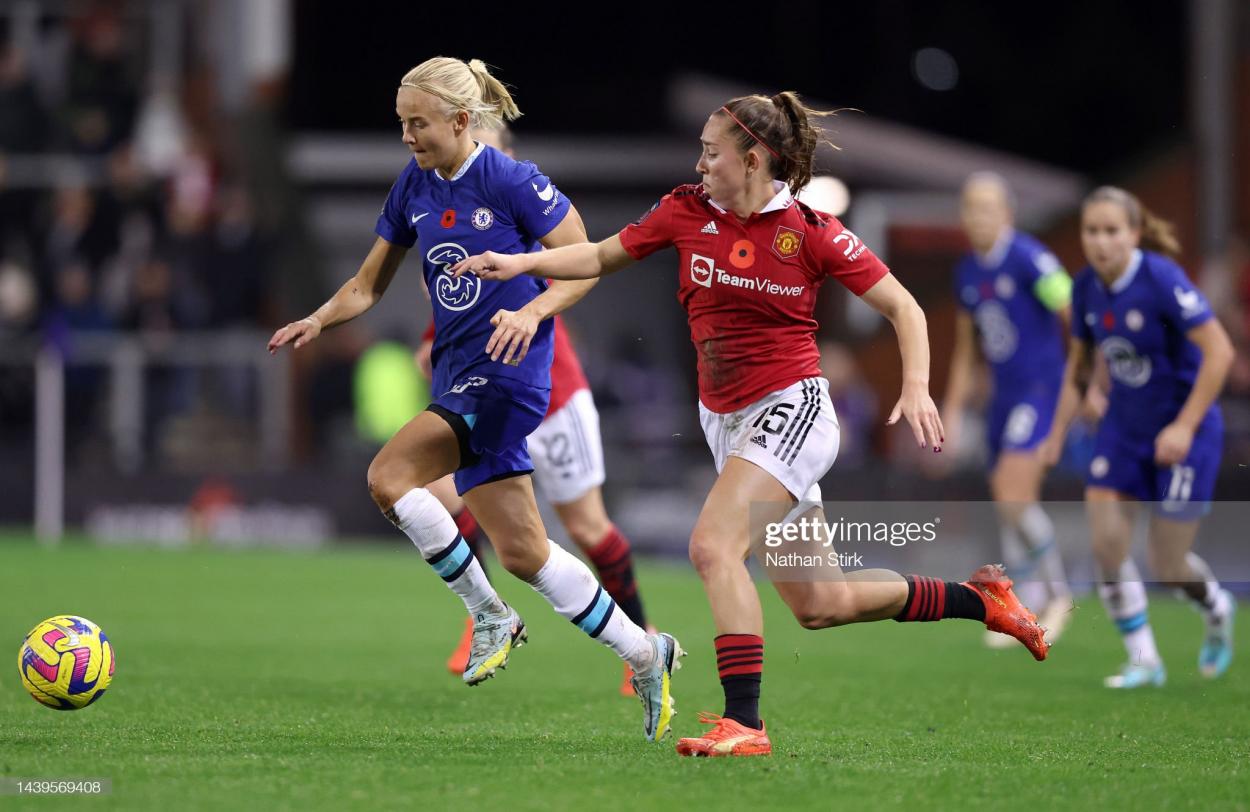 Pernille Harder of Chelsea is challenged by Maya Le Tissier of Manchester United during the FA Women's Super League match between Manchester United and Chelsea at Leigh Sports Village on November 06, 2022 in Leigh, England. (Photo by Nathan Stirk/Getty Images)