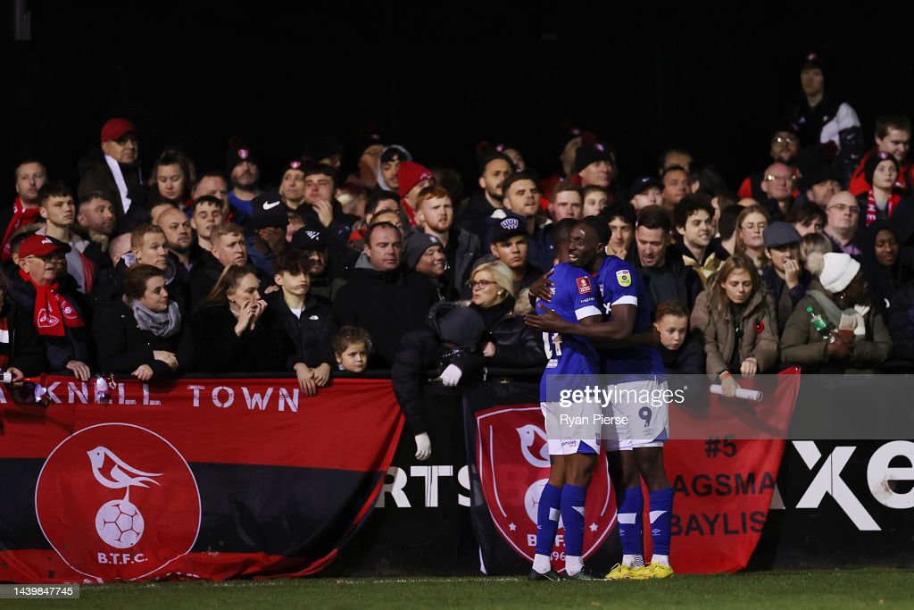 SANDHURST, ENGLAND - NOVEMBER 07: Freddie Ladapo of Ipswich Town (R) celebrates scoring their team's second goal as Bracknell Town fans look on during the FA Cup First Round match between Bracknell Town and Ipswich Town at Bottom Meadow on November 07, 2022 in Sandhurst, England. (Photo by Ryan Pierse/Getty Images)