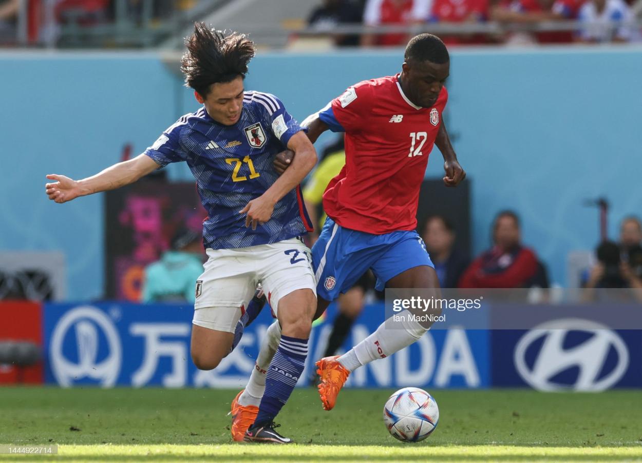 DOHA, QATAR - NOVEMBER 27: Ayase Ueda of Japan vies with Joel Campbell of <strong><a  data-cke-saved-href='https://www.vavel.com/en/international-football/2022/11/23/1130306-world-cup-enrique-rejoices-in-spains-team-of-goalscorers.html' href='https://www.vavel.com/en/international-football/2022/11/23/1130306-world-cup-enrique-rejoices-in-spains-team-of-goalscorers.html'>Costa Rica</a></strong> during the <strong><a  data-cke-saved-href='https://www.vavel.com/en/international-football/2022/11/26/1130558-france-2-1-denmark-mbappe-double-downs-danes-to-secure-group-d-qualification.html' href='https://www.vavel.com/en/international-football/2022/11/26/1130558-france-2-1-denmark-mbappe-double-downs-danes-to-secure-group-d-qualification.html'>FIFA <strong><a  data-cke-saved-href='https://www.vavel.com/en/international-football/2022/11/26/1130568-i-tackled-emre-can-andi-said-because-i-love-you-post-match-quotes-from-dortmund-sailors-match.html' href='https://www.vavel.com/en/international-football/2022/11/26/1130568-i-tackled-emre-can-andi-said-because-i-love-you-post-match-quotes-from-dortmund-sailors-match.html'>World Cup</a></strong></a></strong> Qatar 2022 Group E match between Japan and <strong><a  data-cke-saved-href='https://www.vavel.com/en/international-football/2022/11/23/1130306-world-cup-enrique-rejoices-in-spains-team-of-goalscorers.html' href='https://www.vavel.com/en/international-football/2022/11/23/1130306-world-cup-enrique-rejoices-in-spains-team-of-goalscorers.html'>Costa Rica</a></strong> at Ahmad Bin Ali Stadium on November 27, 2022 in Doha, Qatar. (Photo by Ian MacNicol/Getty Images)