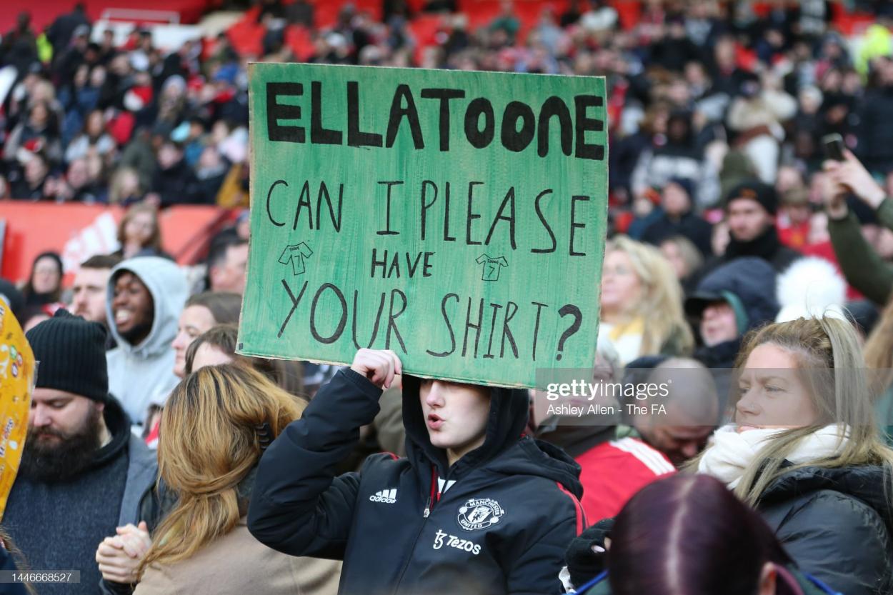 A fan of Manchester United's Ella Toone holds up a sign during the FA Women's Super League match between Manchester United and Aston Villa at Old Trafford on December 03, 2022 in Manchester, England. (Photo by Ashley Allen - The FA/The FA via Getty Images)