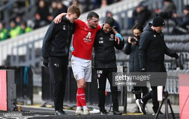  Tom Edwards hobbling off the pitch in Barnsley's last game versus Derby(Photo by Gareth Copley/Getty Images)