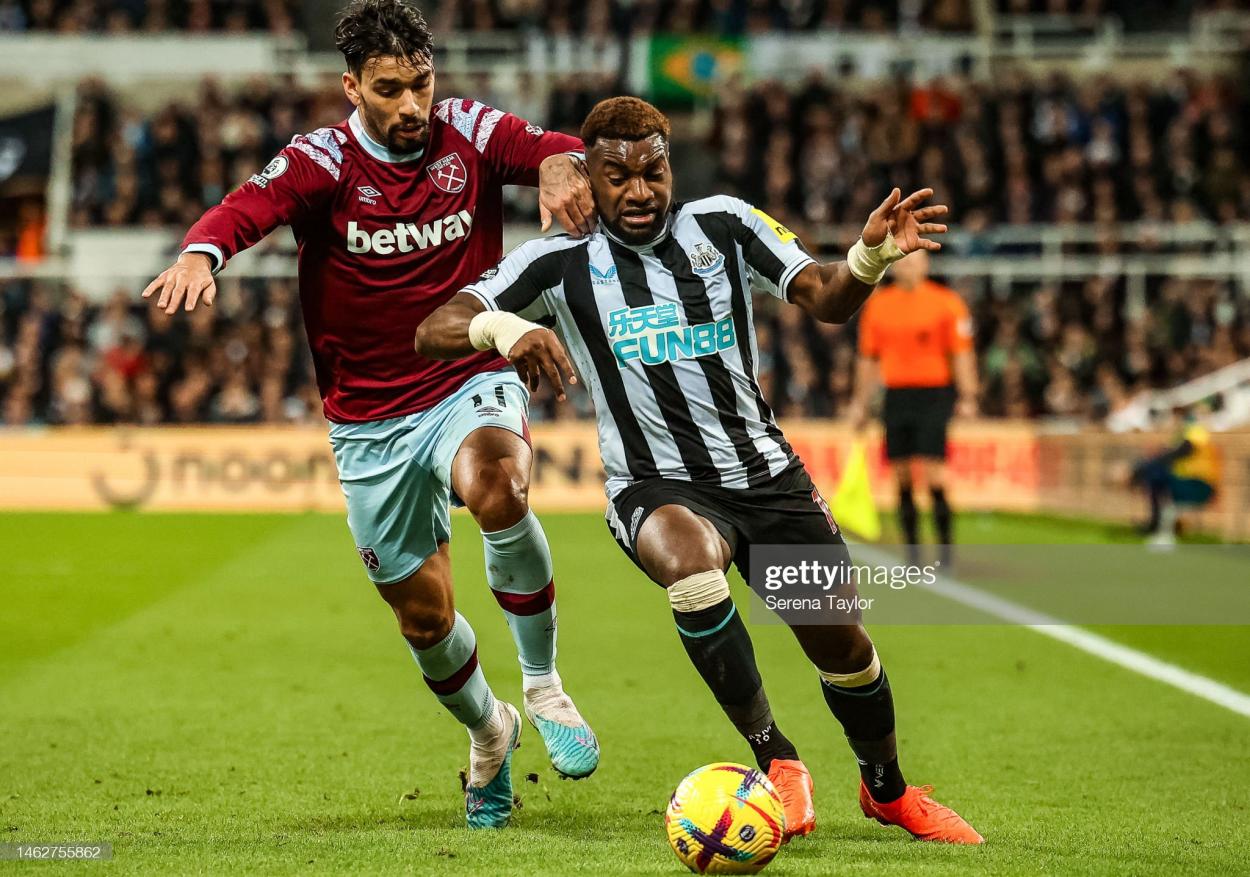 NEWCASTLE UPON TYNE, ENGLAND - FEBRUARY 04: Allan Saint-Maximin of Newcastle United FC (10) shields the ball from Lucas Paqueta of West Ham United (11) during the Premier League match between Newcastle United and West Ham United at St. James Park on February 04, 2023 in Newcastle upon Tyne, England. (Photo by Serena Taylor/Newcastle United via Getty Images)