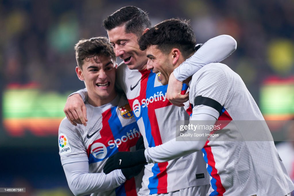 Pedri and Gavi celebrate with Robert Lewandowski following another one of his goals