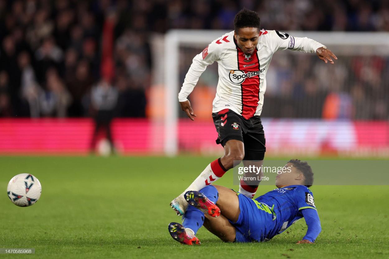Michee Efete of Grimsby Town tackles Kyle Walker-Peters of Southampton during the Emirates FA Cup Fifth Round match between Southampton and Grimsby Town at St Mary's Stadium on March 01, 2023 in Southampton, England. (Photo by Warren Little/Getty Images)