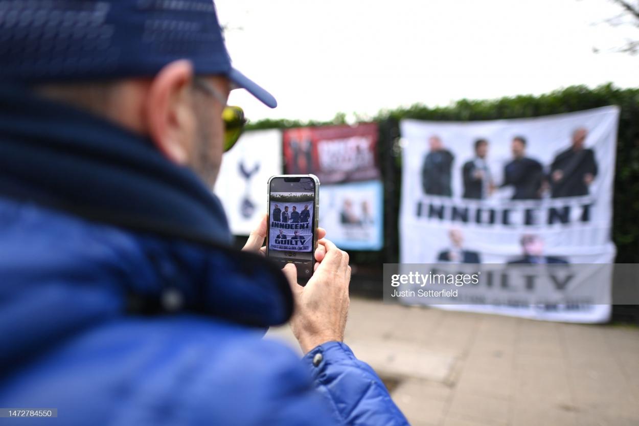 Spurs fan takes picture of protest towards ownership. (Photo by Justin Setterfield/Getty Images)