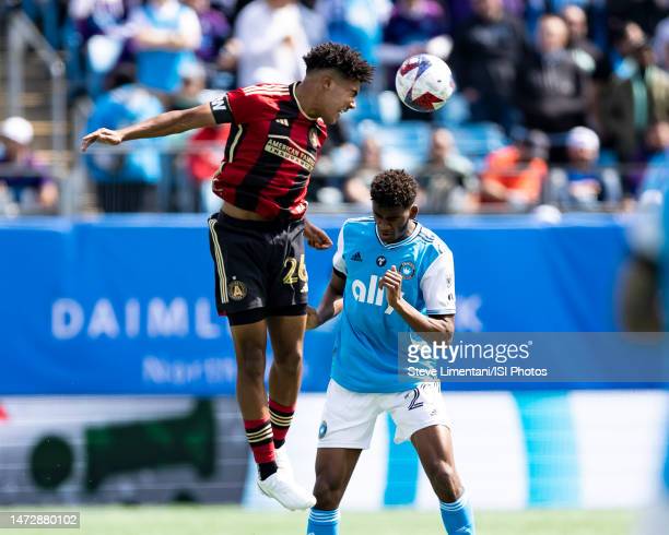 Atlanta United's Caleb Wiley heads the ball against Charlotte FC's Adilson Malanda/Photo: Steve Limentani/ISI Photos/Getty Images