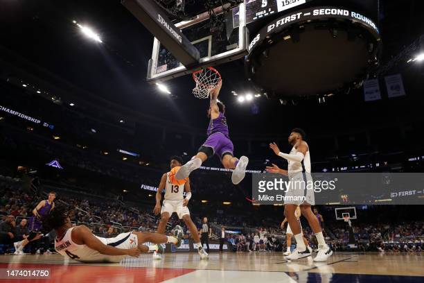 Jalen Slawson dunks over Virginia defenders during the Paladins[ first-round NCAA Tournament win/Photo: Mike Ehrmann/Getty Images