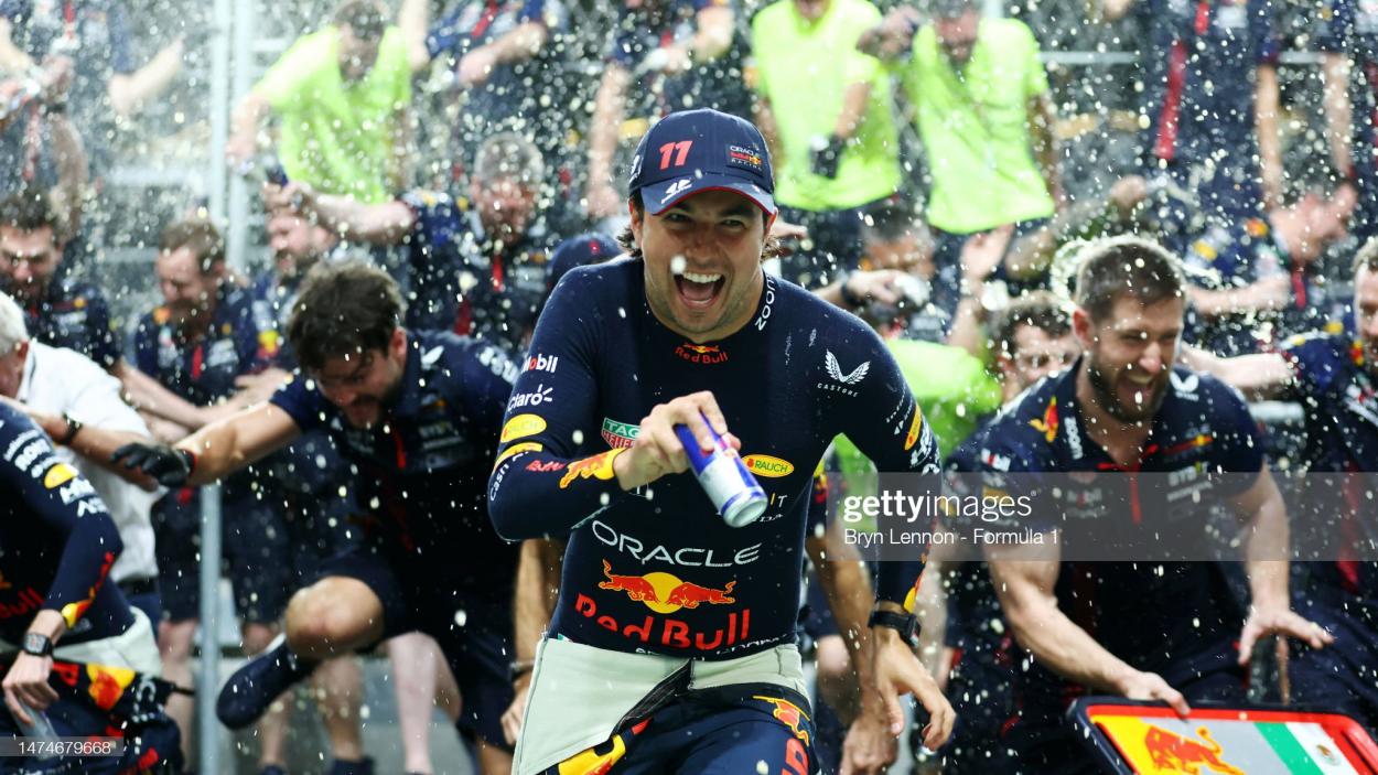 JEDDAH, SAUDI ARABIA - MARCH 19: Race winner <strong><a  data-cke-saved-href='https://www.vavel.com/en/motorsports/2023/03/05/formula-1/1139686-driver-and-constructor-ratings-verstappen-cruises-to-bahrain-gp-victory.html' href='https://www.vavel.com/en/motorsports/2023/03/05/formula-1/1139686-driver-and-constructor-ratings-verstappen-cruises-to-bahrain-gp-victory.html'>Sergio Perez</a></strong> of Mexico and Oracle Red Bull Racing and the Red Bull Racing team celebrate after the F1 Grand Prix of Saudi Arabia at Jeddah Corniche Circuit on March 19, 2023 in Jeddah, Saudi Arabia. (Photo by Bryn Lennon - Formula 1/Formula 1 via Getty Images)