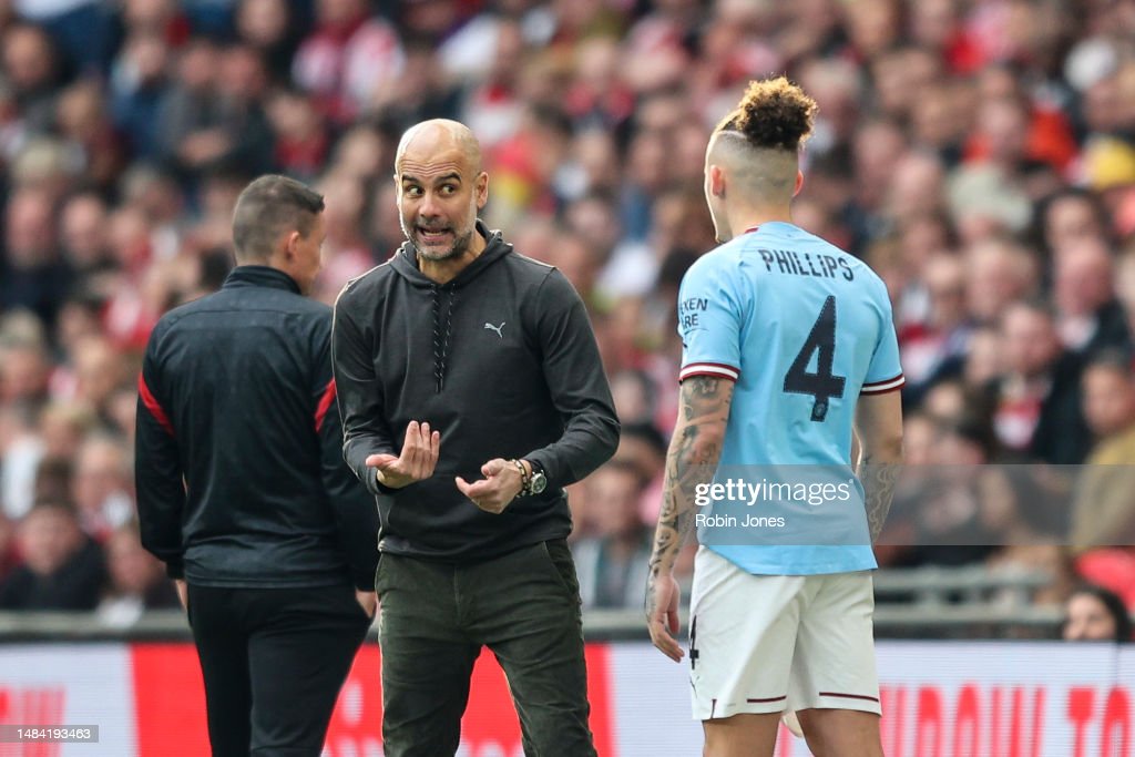LONDON, ENGLAND - APRIL 22: Head Coach Pep Guardiola gives instruction to Kalvin Phillips of Manchester City during the FA Cup semi-final between Manchester City and Sheffield United at Wembley Stadium on April 22, 2023 in London, England. (Photo by Robin Jones/Getty Images)