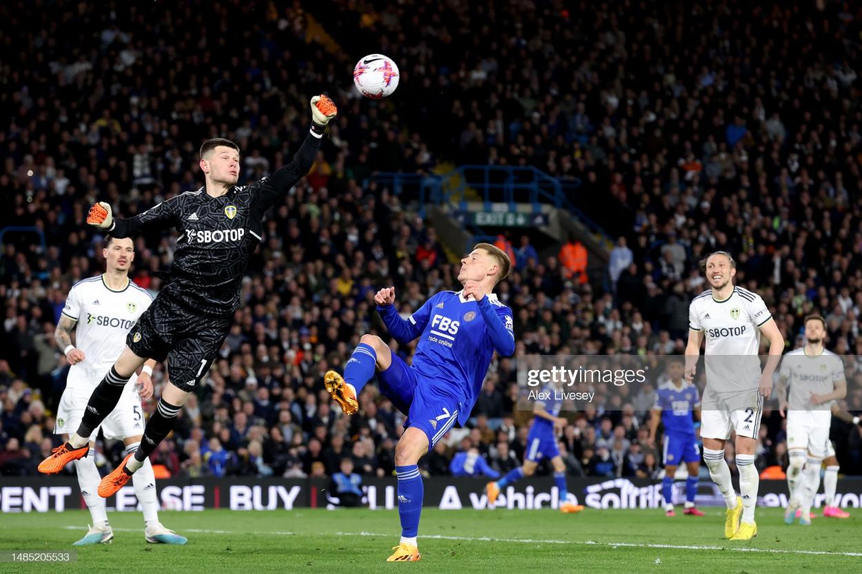 Illan Meslier of Leeds United punches the ball whilst under pressure from Harvey Barnes of Leicester City. (Photo by Alex Livesey/Getty Images)