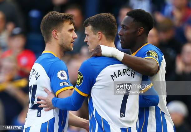 Danny Welbeck celebrates with teammates Solly March and Joel Veltman (Photo by Charlie Crowhurst/Getty Images)