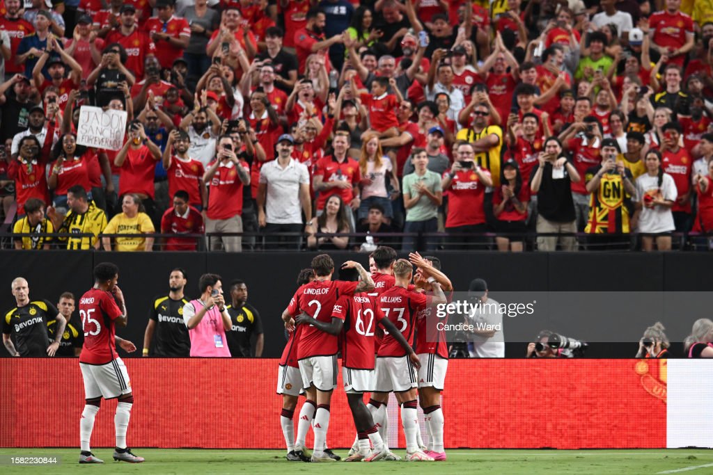LAS VEGAS, NEVADA - JULY 30: <strong><a  data-cke-saved-href='https://www.vavel.com/en/football/2023/07/03/manchester-united/1150357-david-beckham-manchester-uniteds-culture-has-changed-since-sir-alex-ferguson-but-we-are-still-the-greatest-and-biggest-club-in-the-world.html' href='https://www.vavel.com/en/football/2023/07/03/manchester-united/1150357-david-beckham-manchester-uniteds-culture-has-changed-since-sir-alex-ferguson-but-we-are-still-the-greatest-and-biggest-club-in-the-world.html'>Manchester United</a></strong> celebrates a goal by <strong><a  data-cke-saved-href='https://www.vavel.com/en/football/2022/10/06/manchester-united/1125404-omonia-nicosia-2-3-manchester-united-three-things-we-learnt.html' href='https://www.vavel.com/en/football/2022/10/06/manchester-united/1125404-omonia-nicosia-2-3-manchester-united-three-things-we-learnt.html'>Diogo Dalot</a></strong> #20 of <strong><a  data-cke-saved-href='https://www.vavel.com/en/football/2023/07/03/manchester-united/1150357-david-beckham-manchester-uniteds-culture-has-changed-since-sir-alex-ferguson-but-we-are-still-the-greatest-and-biggest-club-in-the-world.html' href='https://www.vavel.com/en/football/2023/07/03/manchester-united/1150357-david-beckham-manchester-uniteds-culture-has-changed-since-sir-alex-ferguson-but-we-are-still-the-greatest-and-biggest-club-in-the-world.html'>Manchester United</a></strong> during the pre-season friendly match against Borussia Dortmund at Allegiant Stadium on July 30, 2023 in Las Vegas, Nevada. (Photo by Candice Ward/Getty Images)