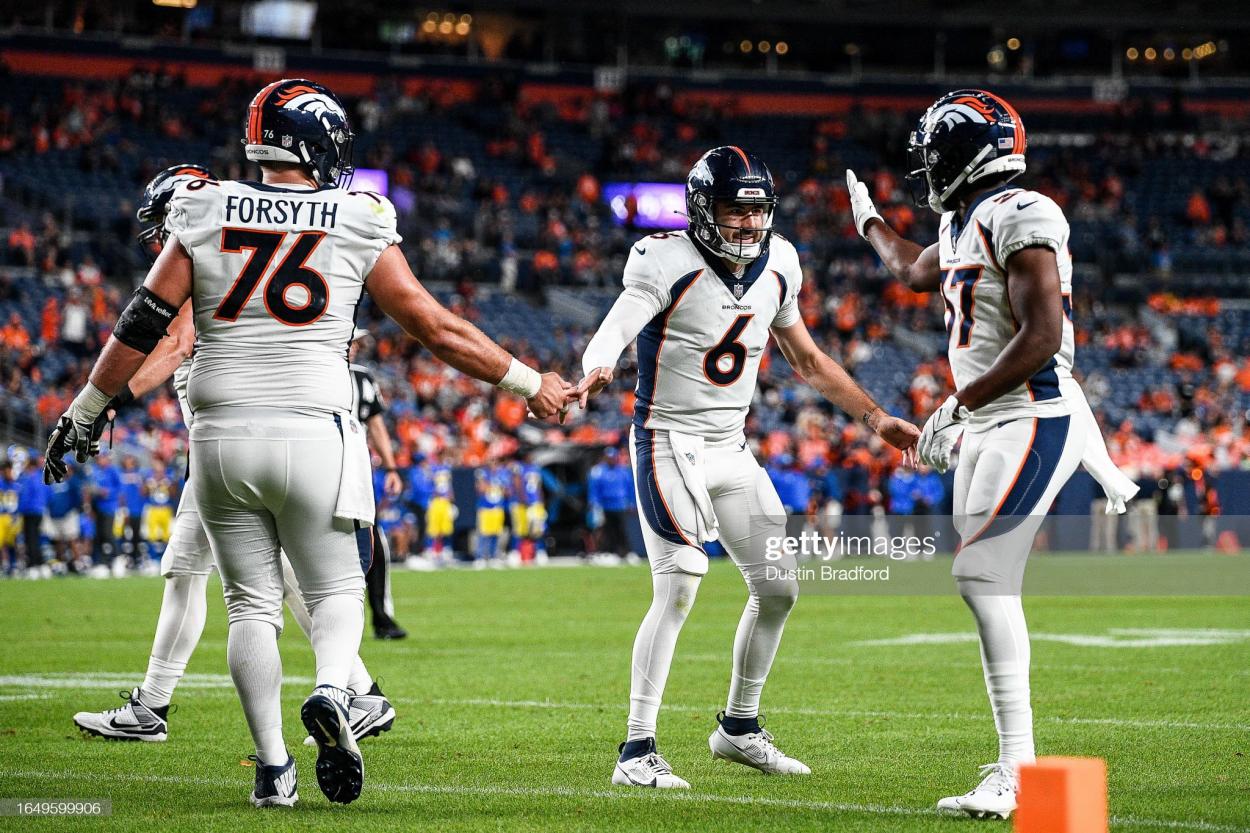 Quarterback Ben DiNucci #6, center Alex Forsyth #76, and Josh Hammond #37 of the Denver Broncos celebrate a in the fourth quarter of the preseason game at Empower Field at Mile High on August 26, 2023 in Denver, Colorado. (Photo by Dustin Bradford/Getty Images)