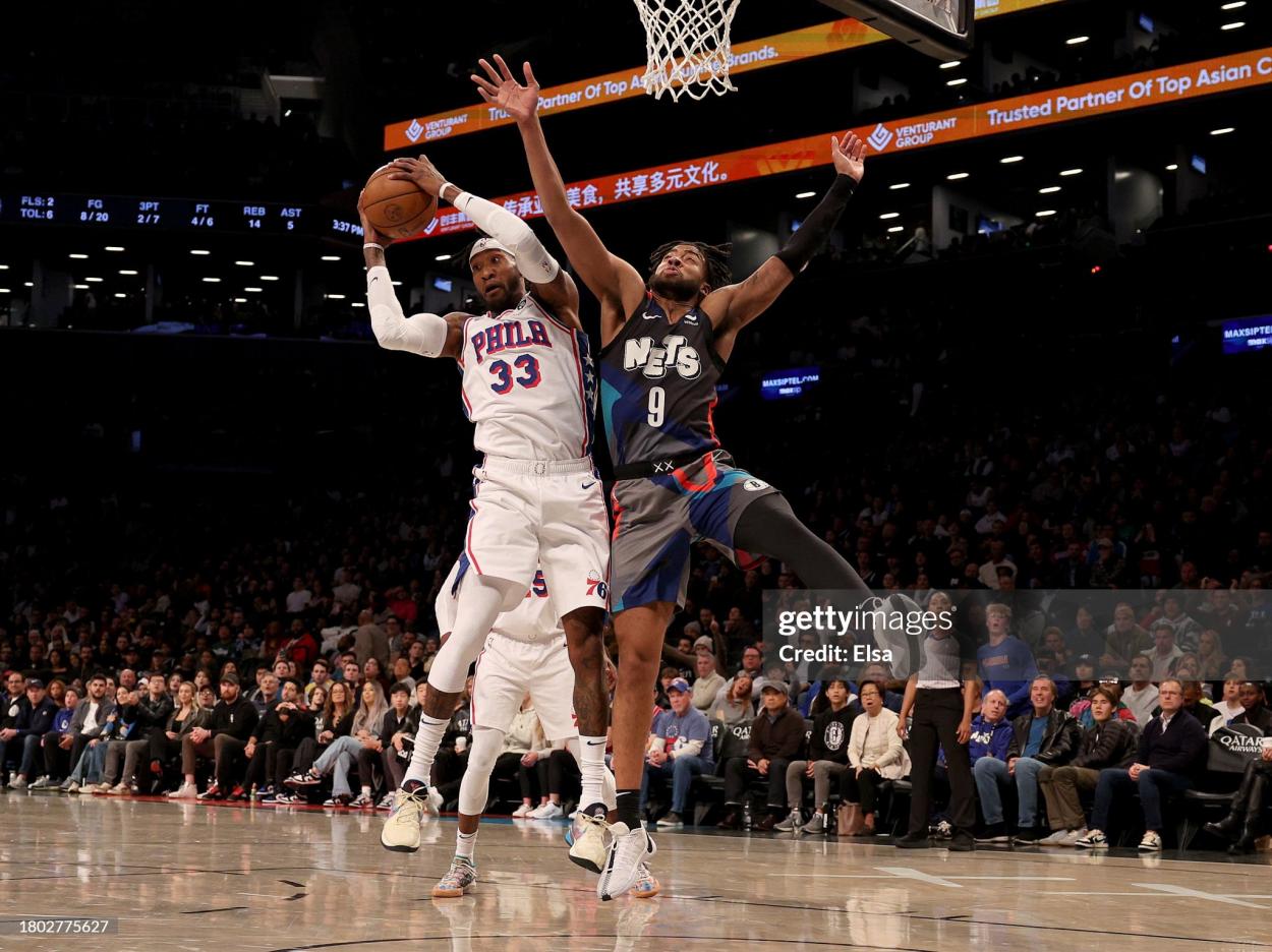Robert Covington and Trendon Watford battle for the rebound (Photo by Elsa/Getty Images)