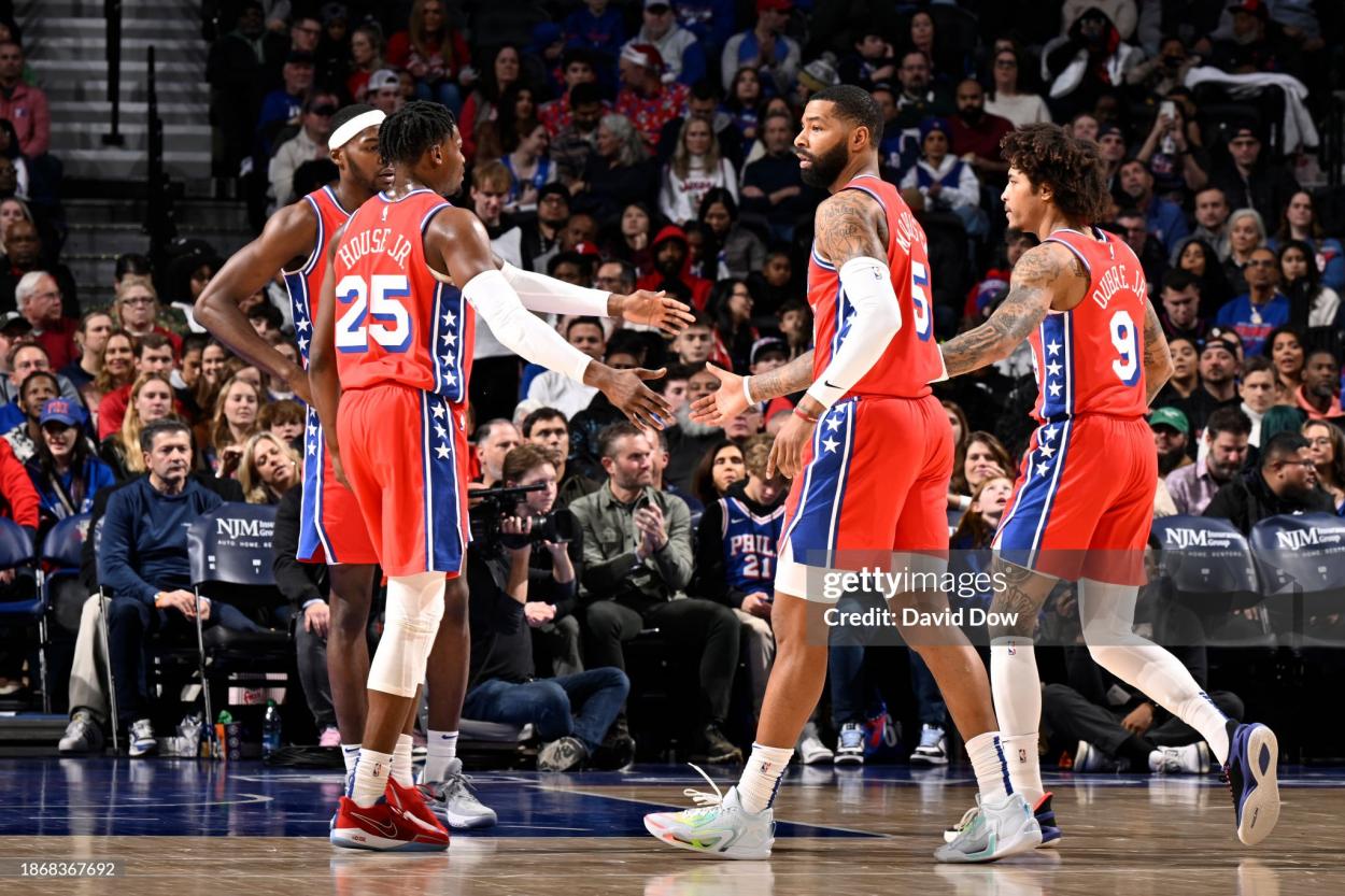 Several 76ers players celebrate following a basket (Photo by David Dow/NBAE via Getty Images)