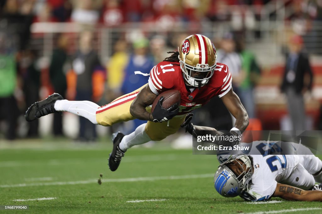 SANTA CLARA, CALIFORNIA - JANUARY 28: Brandon Aiyuk #11 of the San Francisco 49ers catches a pass that was tipped by Kindle Vildor #29 of the Detroit Lions during the third quarter in the NFC Championship Game at Levi's Stadium on January 28, 2024 in Santa Clara, California. (Photo by Ezra Shaw/Getty Images)