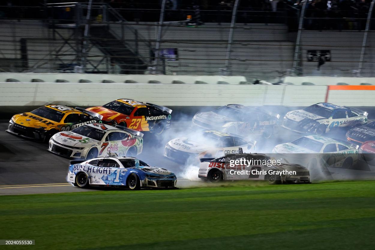 DAYTONA BEACH, FLORIDA - FEBRUARY 19: Ross Chastain, driver of the #1 Busch Light Chevrolet, and Austin Cindric, driver of the #2 Discount Tire Ford, spin after an on-track incident during the NASCAR Cup Series Daytona 500 at Daytona International Speedway on February 19, 2024 in Daytona Beach, Florida. (Photo by Chris Graythen/Getty Images)