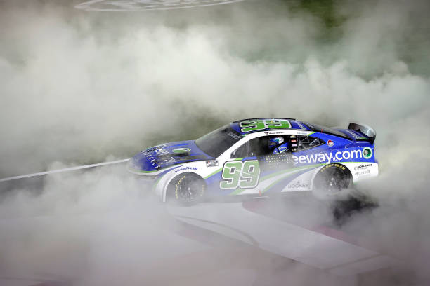 HAMPTON, GEORGIA - FEBRUARY 25: Daniel Suarez, driver of the #99 Freeway Insurance Chevrolet, celebrates with a burnout after winning the NASCAR Cup Series Ambetter Health 400 at Atlanta Motor Speedway on February 25, 2024 in Hampton, Georgia. (Photo by Alex Slitz/Getty Images)