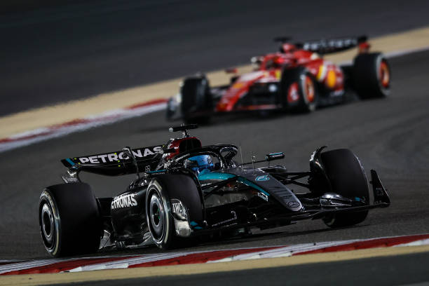George Russell of Great Britain driving the (63) Mercedes AMG Petronas F1 Team W15 on track and Charles Leclerc of Monaco driving the (16) Ferrari SF-24 on track during the F1 Grand Prix of Bahrain at Bahrain International Circuit on March 02, 2024 in Bahrain, Bahrain. (Photo by Eric Alonso/Getty Images )