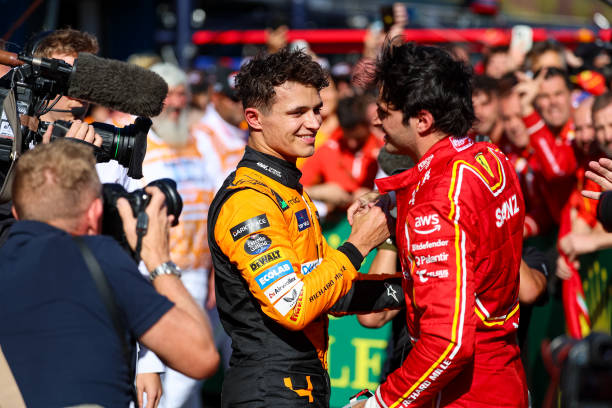Lando Norris of Great Britain and McLaren F1 and Carlos Sainz of Spain and Scuderia Ferrari share a hug in parc ferme after the F1 Grand Prix of Australia at Albert Park Circuit on March 24, 2024 in Melbourne, Australia. (Photo by Kym Illman/Getty Images)
